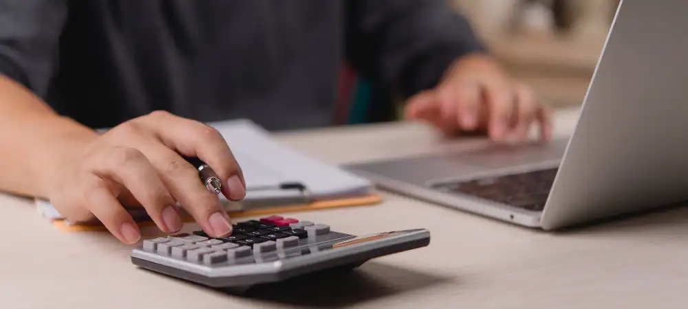 retail-buildout-budgeting Retail manager using calculator to complete retail buildout budgeting